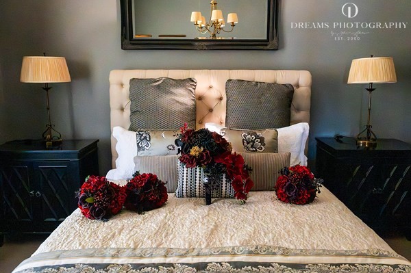Celine in a striking black wedding dress with a deep red bouquet at Burnham Grove Estate, Camden Sydney