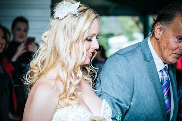 Tina and Stephen's reception under the bushland canopy at The Retreat Port Stephens — guests, toasts and the outdoor function area in spring afternoon light