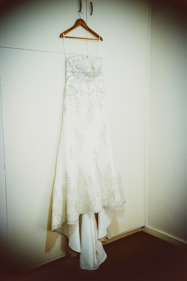 Tina getting ready in a bushland cabin at The Retreat Port Stephens — the wedding dress and details in soft spring morning light
