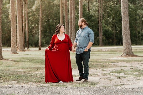 Mom and dad walking and holding hands at Rustic Ridge, Deridder Louisiana