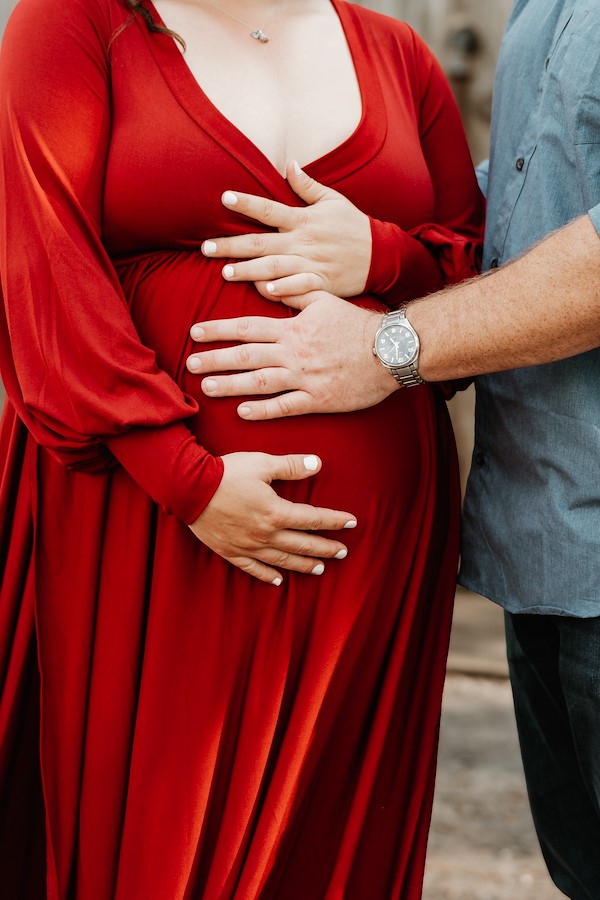 Mom and dad touching belly at Rustic Ridge, Deridder Louisiana
